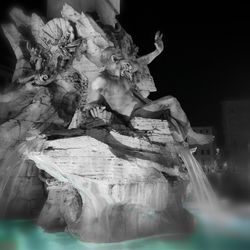 Statue of angel at night