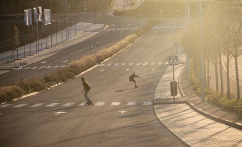 People skating on road