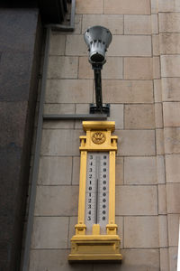 Low angle view of information sign on wall of building