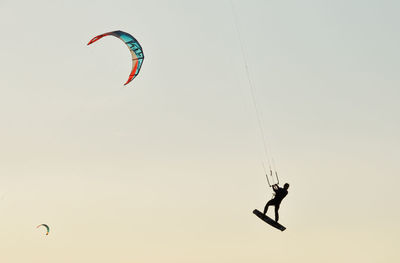 Low angle view of person paragliding