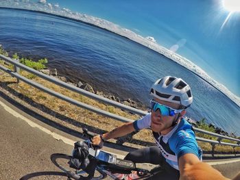 Man riding bicycle on shore