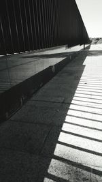 Shadow of road by building