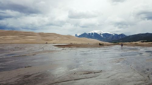 Scenic view of mountains against cloudy sky