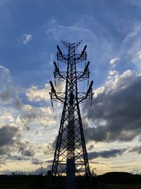 Low angle view of silhouette electricity pylon against sky during sunset