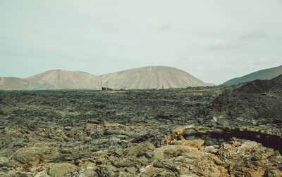 View of volcanic landscape against sky