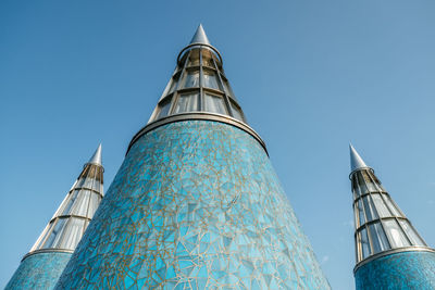 Low angle view of modern building against blue sky