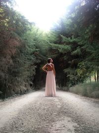 Woman standing on footpath