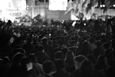 Crowd in illuminated city at night