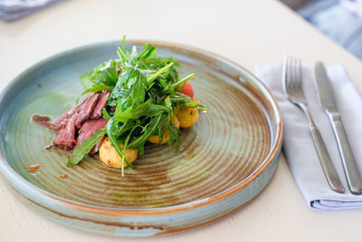 High angle view of vegetables in plate on table