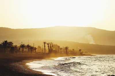 Scenic view of sea against clear sky at sunset 