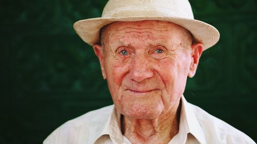 Close-up portrait of man wearing hat