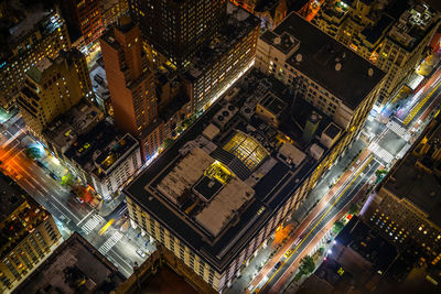 High angle view of illuminated city street and buildings at night