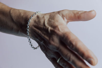 Close-up of hands over white background