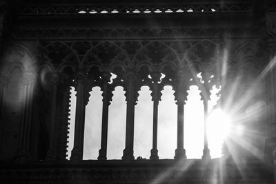 Low angle view of sunlight streaming through old building