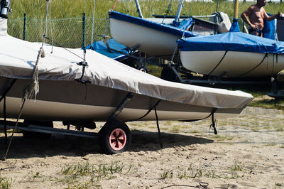 Covered boats on sand at beach