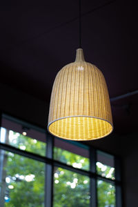 Low angle view of illuminated pendant light hanging from ceiling