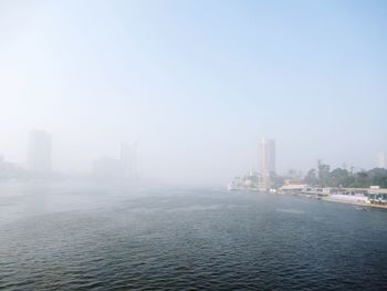 Scenic view of buildings in city against sky
