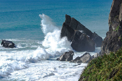 Waves breaking on rocks at shore