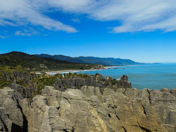 Scenic view of mountains against blue sky