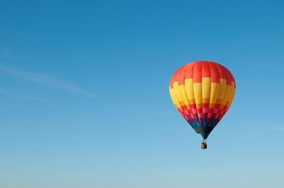 Low angle view of hot air balloon against blue sky