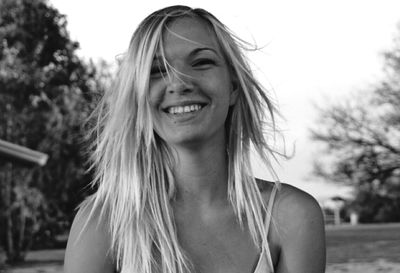 Portrait of smiling woman with dyed hair at park