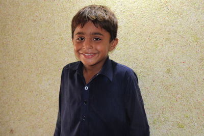 Portrait of smiling boy standing outdoors