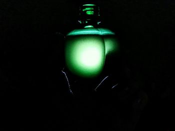 Close-up of illuminated lamp against black background