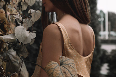 Rear view of woman standing by plants