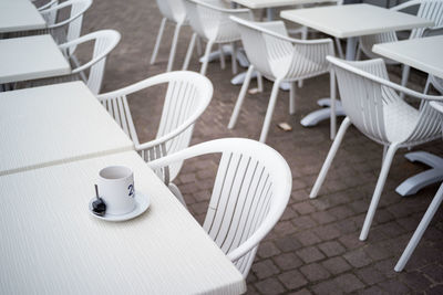 High angle view of empty chairs and tables at cafe