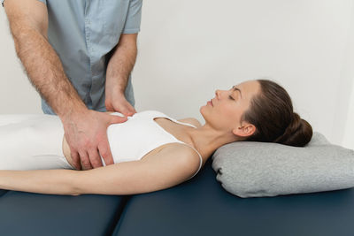 Osteopathic belly massage. female patient receiving osteopathic belly or tummy treatment