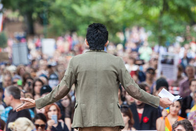 Rear view of people standing outdoors