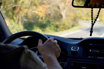 Midsection of man driving car