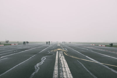 Distance shot of people walking on road