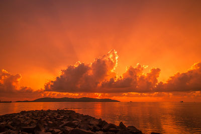 Scenic view of sea against romantic sky at sunset