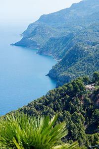 High angle view of sea and mountains against sky