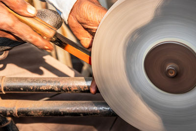 Close-up of man working on machine