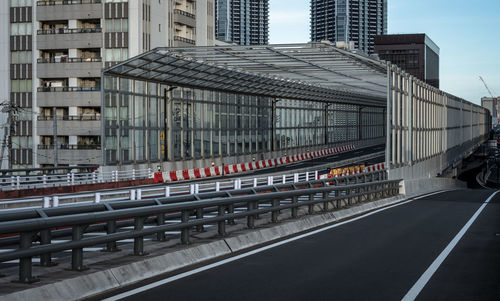 Road by buildings in city