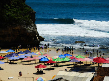 Group of people enjoying at beach during summer