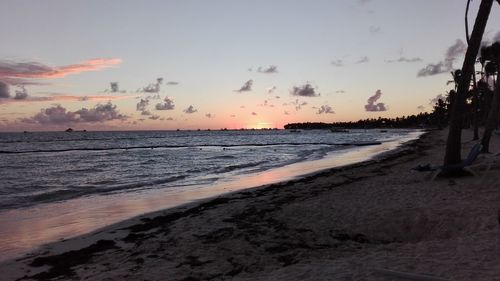 Scenic view of beach against sky during sunset