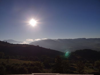 Scenic view of mountains against sky on sunny day