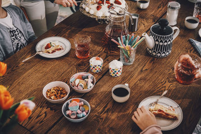 High angle view of family enjoying meal at table during birthday party