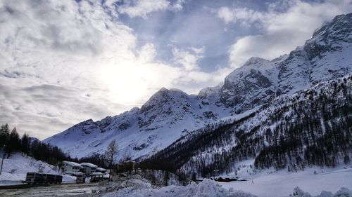 Scenic view of snow covered mountains against sky