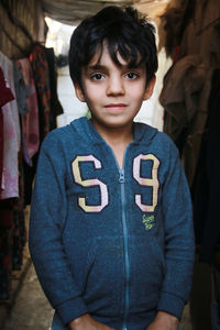 A portrait of a sweet refugee child in the camp. syrian refugees.