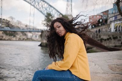 Portrait of young woman in city