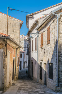 Clothes drying outside house against sky