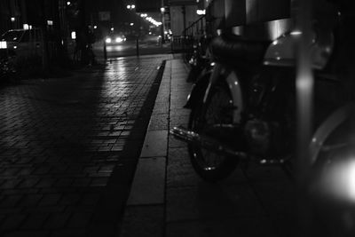 Cars on illuminated street at night