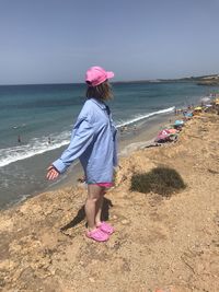 Rear view of woman standing on beach