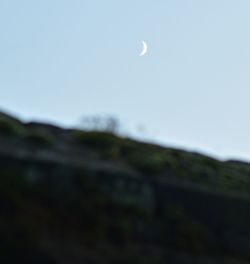 Low angle view of moon against clear sky