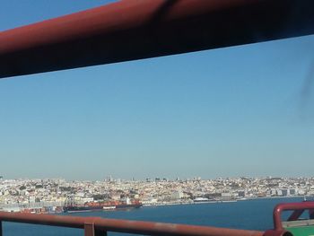 Cityscape against clear blue sky