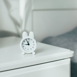 Close-up of clock on table at home